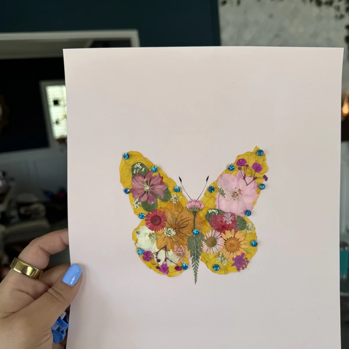 A pressed flower butterfly keepsake in yellow tones