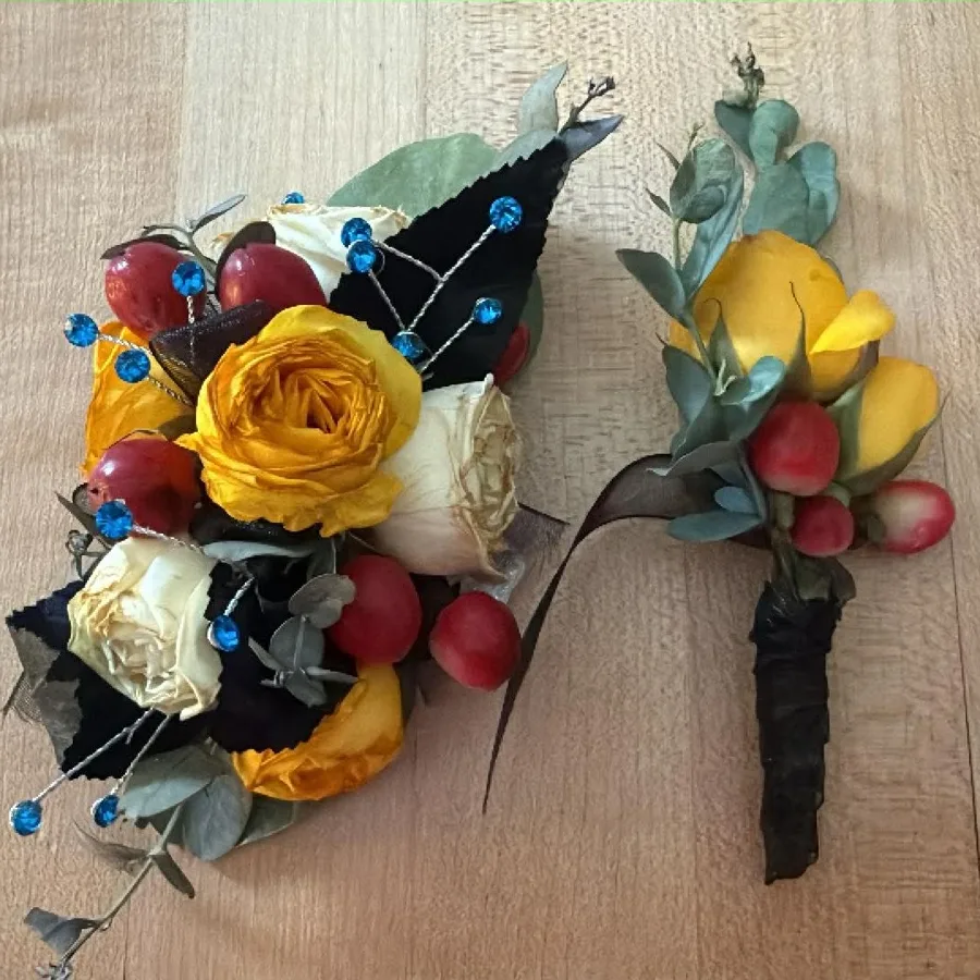 A fresh yellow rose arrangement with berries