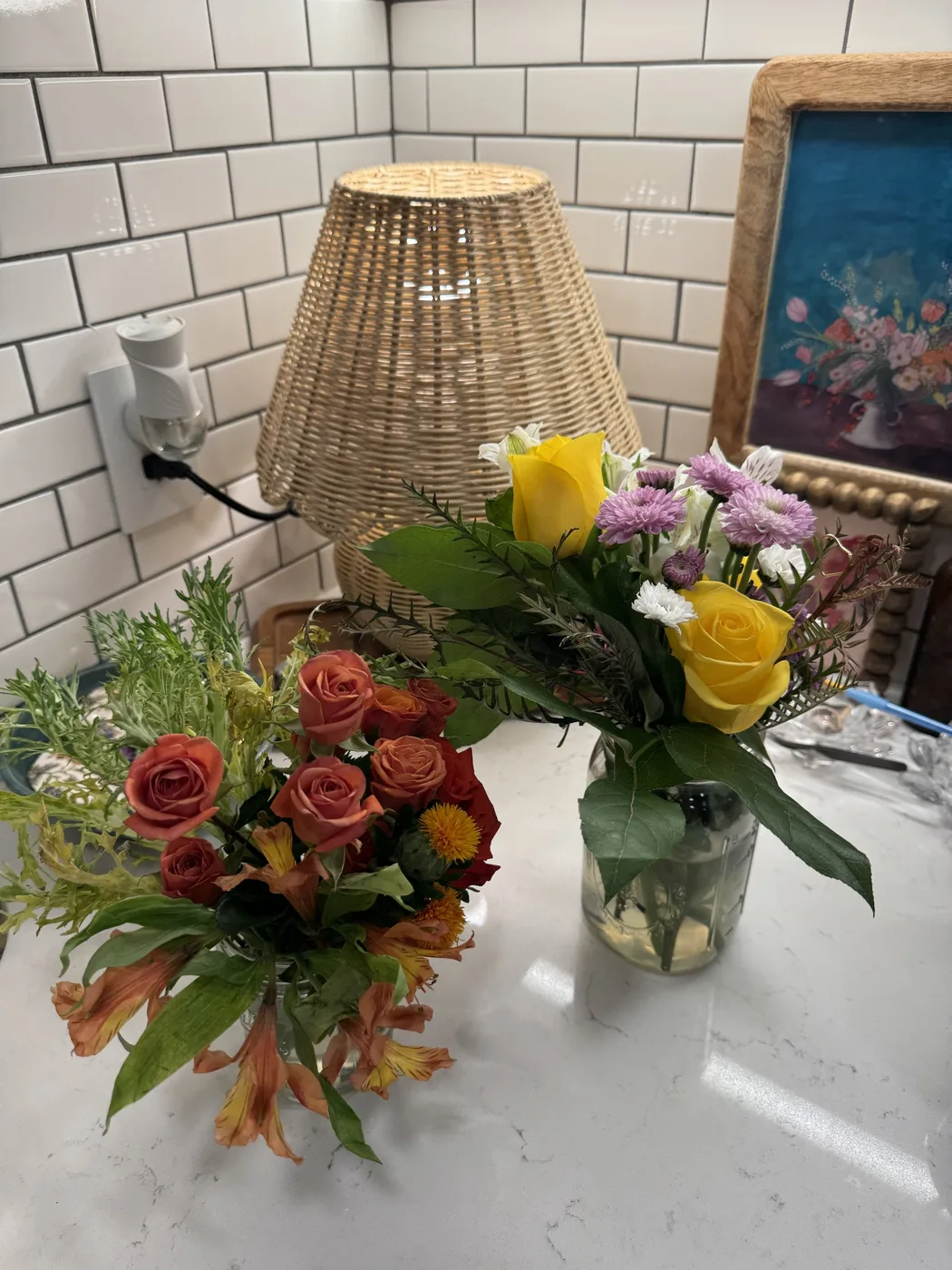 Funeral arrangements of orange roses and yellow lilies