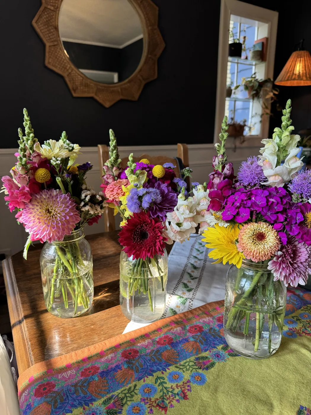 Three fresh mixed bouquets in mason jars